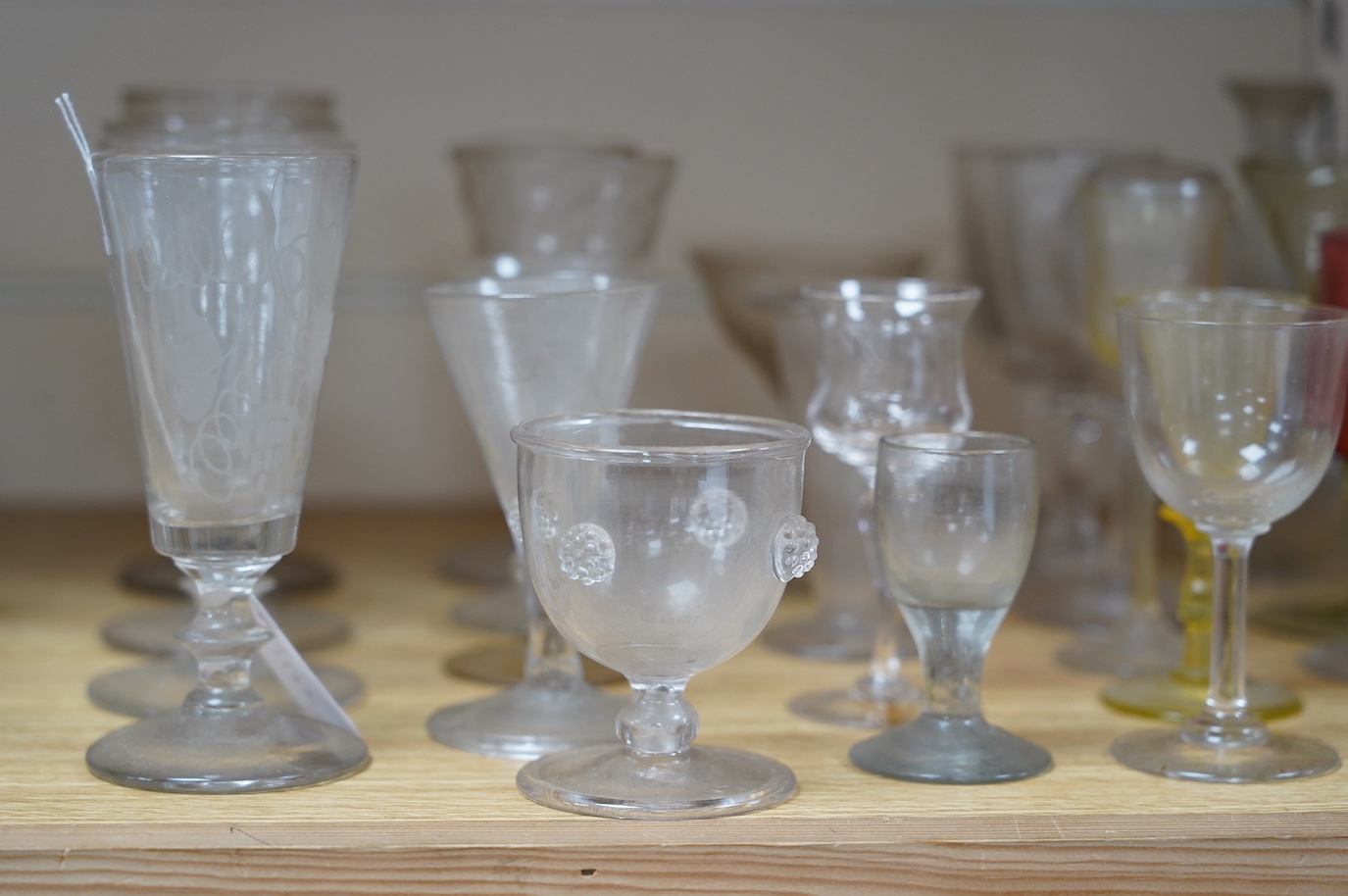 A large cut glass centrepiece, 26cm high, a pair of cut glass decanters and a collection of small glasses from 18th to 20th century. Condition - fair, difficult to see damage as most items need a thorough wash
